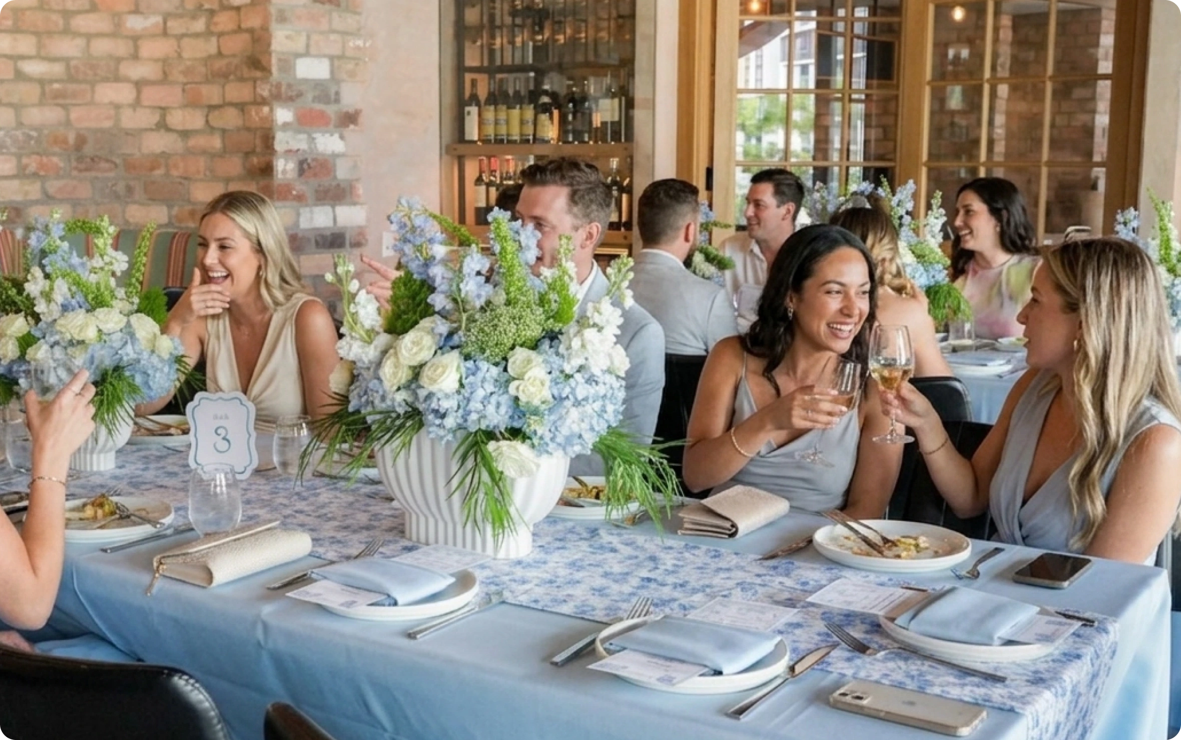 Guests celebrating around a flower-filled table at Novecento Doral