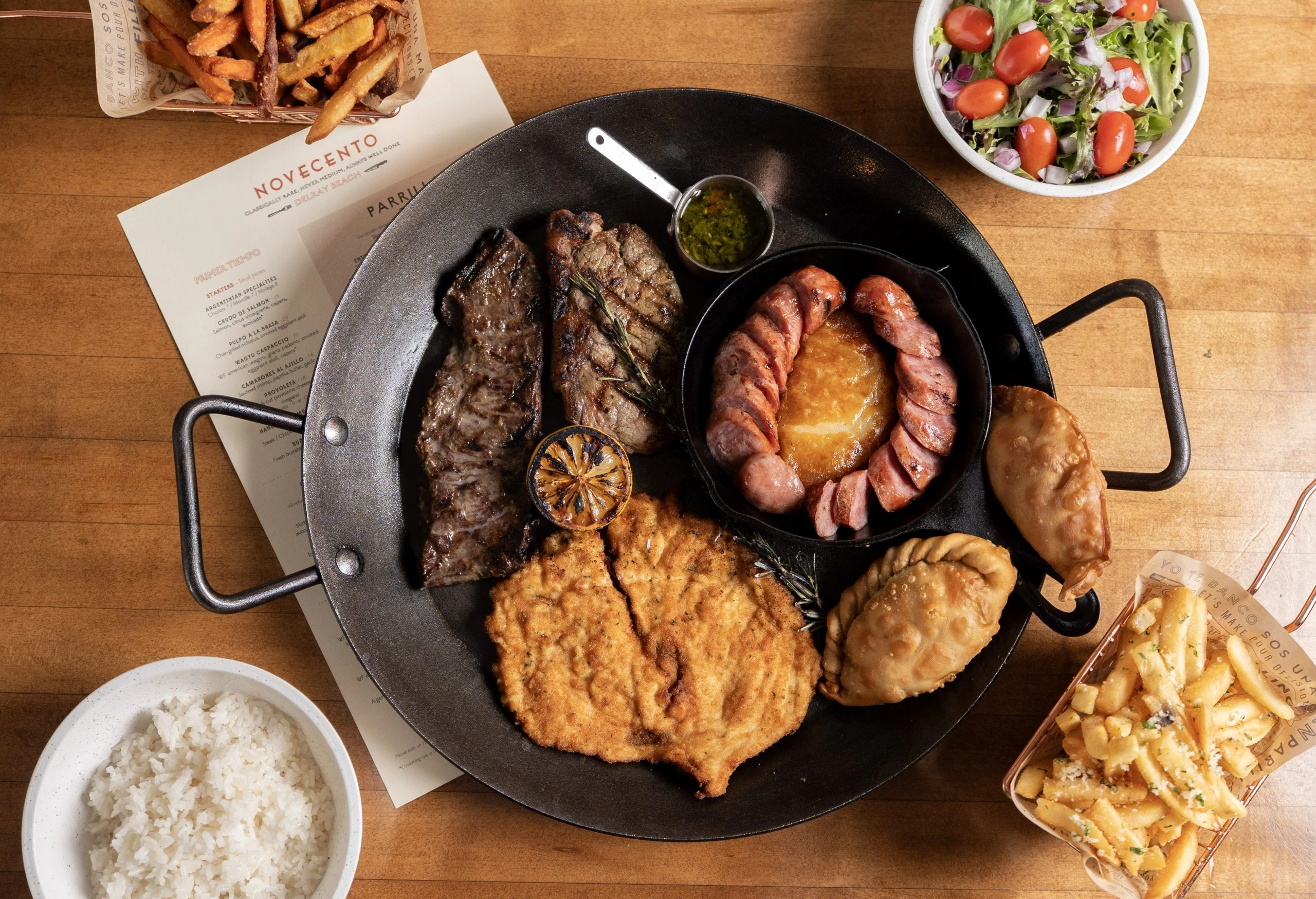 An Argentine parrilla with empanadas and house sides